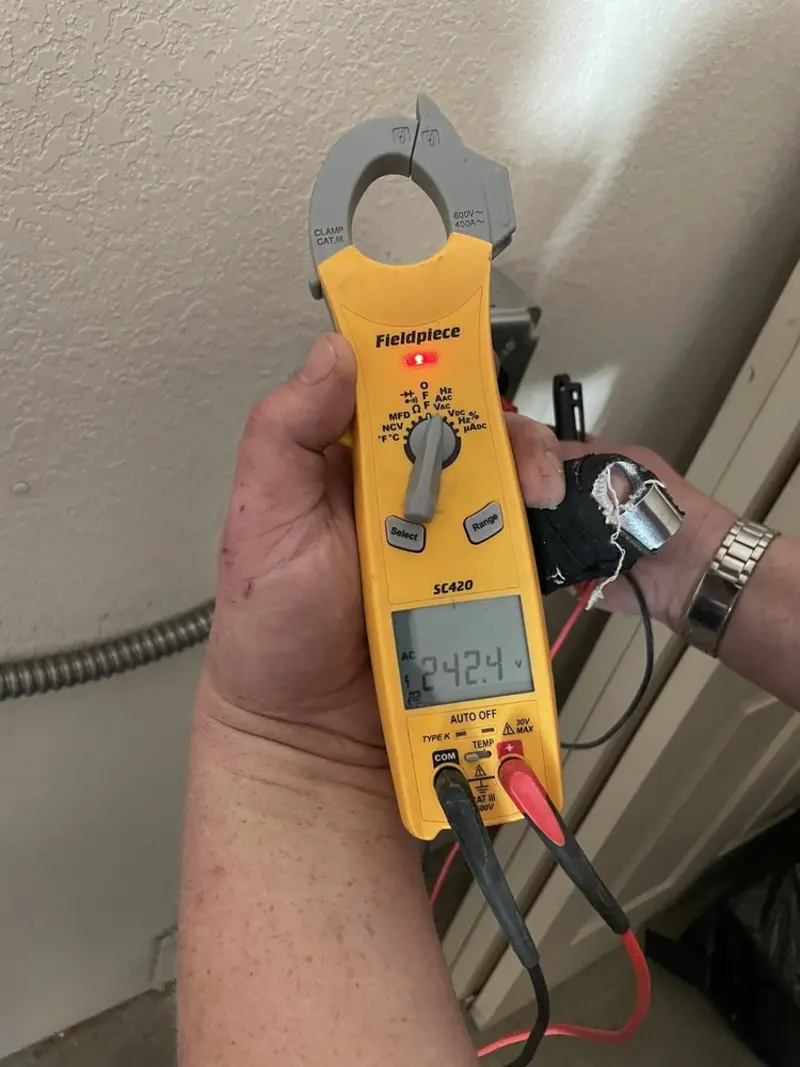 Voltage testing with clamp meter during Whole House Surge Protector in Midlothian